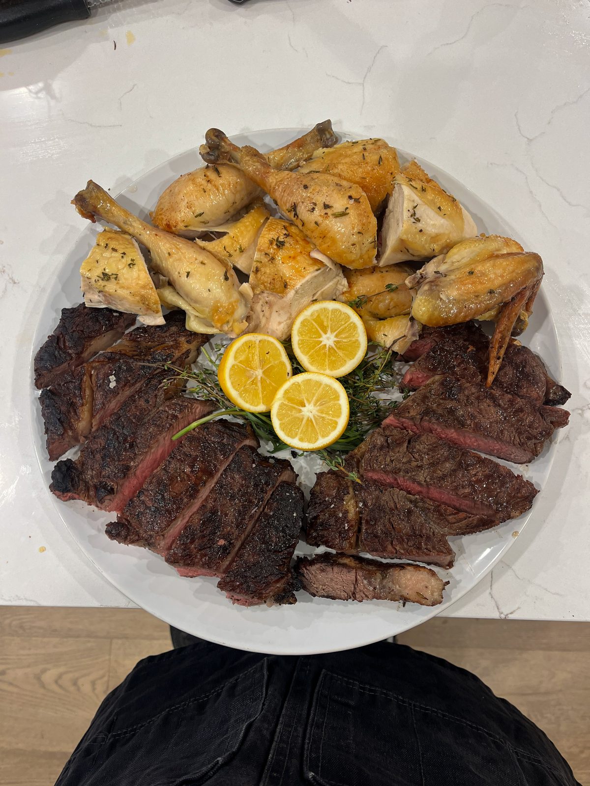Grilled bone-in ribeye and roasted chicken platter with citrus